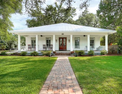 white house with burgundy metal porch roof|white house with white windows.